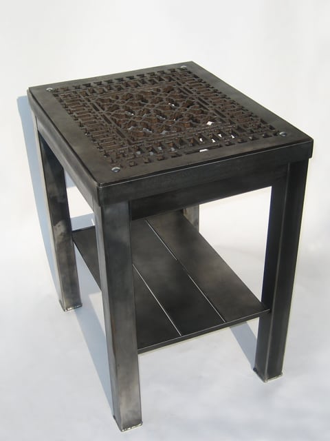 steel end table with intricate design cutouts