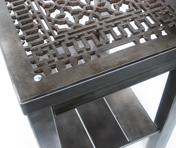 steel end table with intricate design cutouts