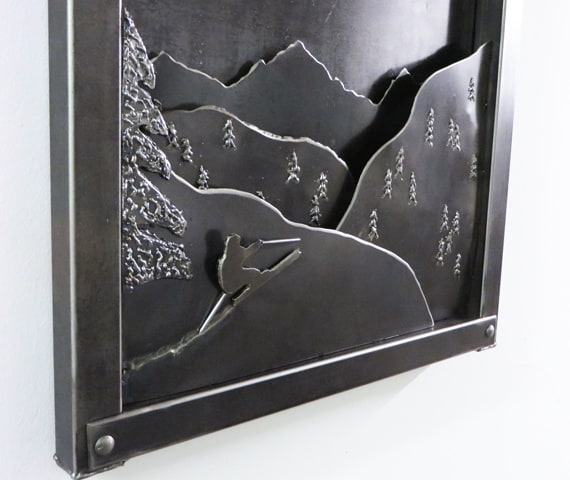 metal artwork with mountains