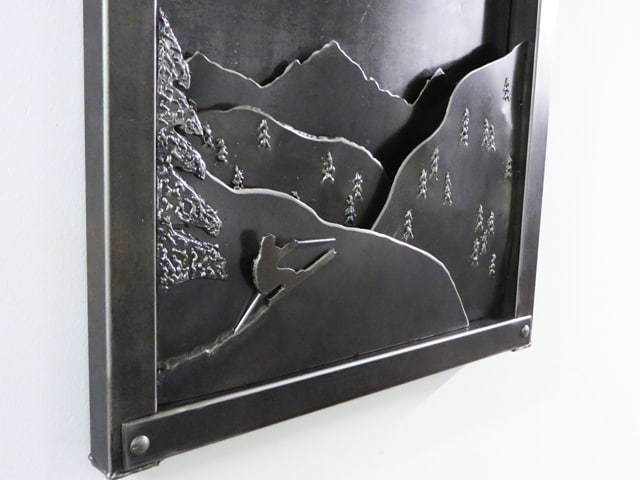 metal artwork with mountains