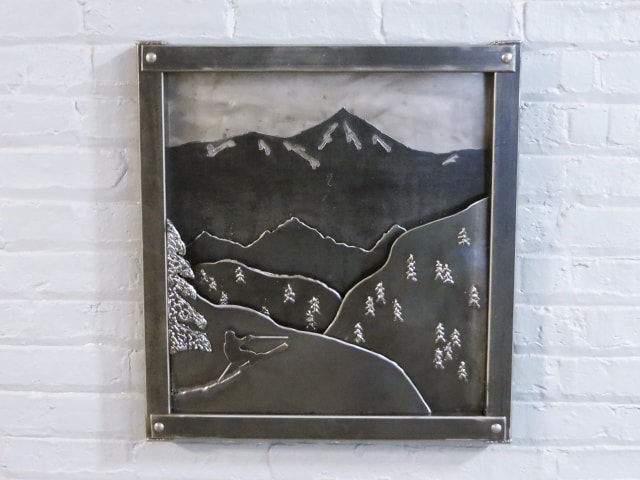 metal artwork with mountains
