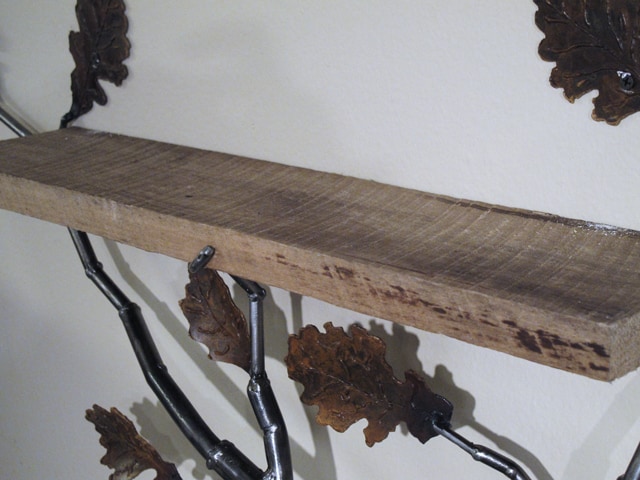 metal shelf with branches and leaves