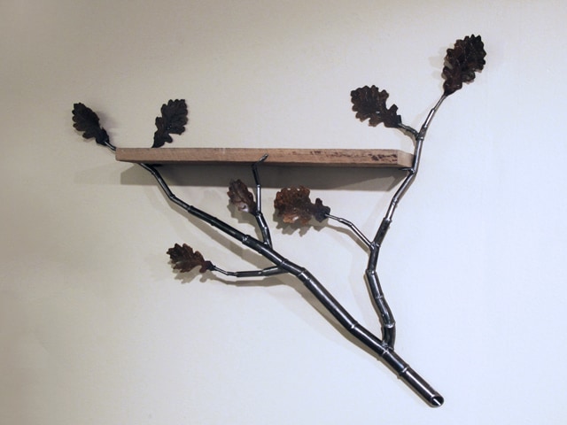metal shelf with branches and leaves