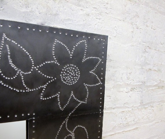 steel mirror with punched flower design