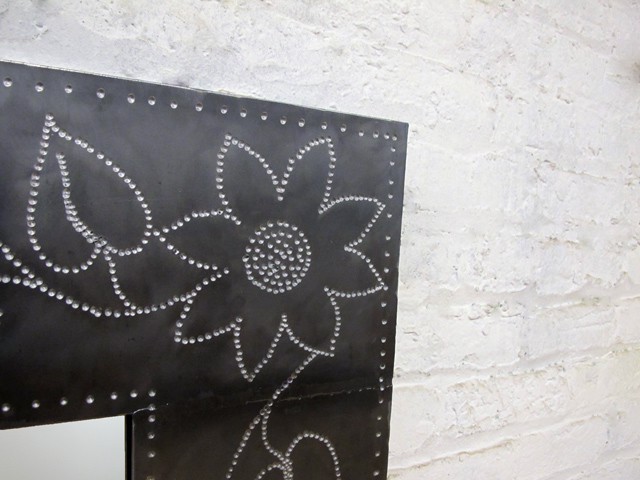 steel mirror with punched flower design